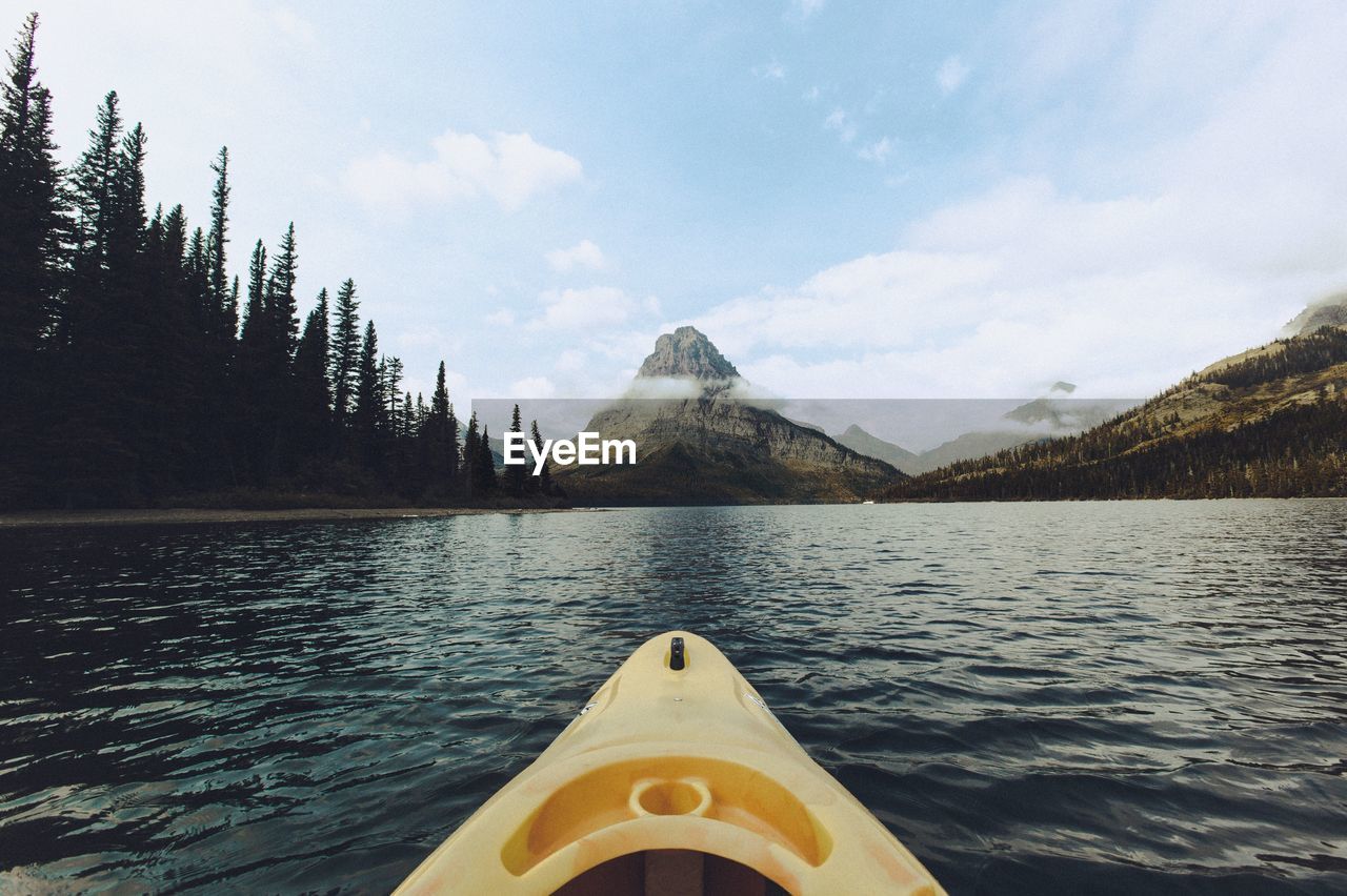 Scenic view of lake by mountain against sky