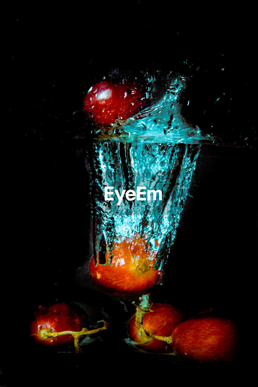 CLOSE-UP OF ICE CREAM AGAINST BLACK BACKGROUND