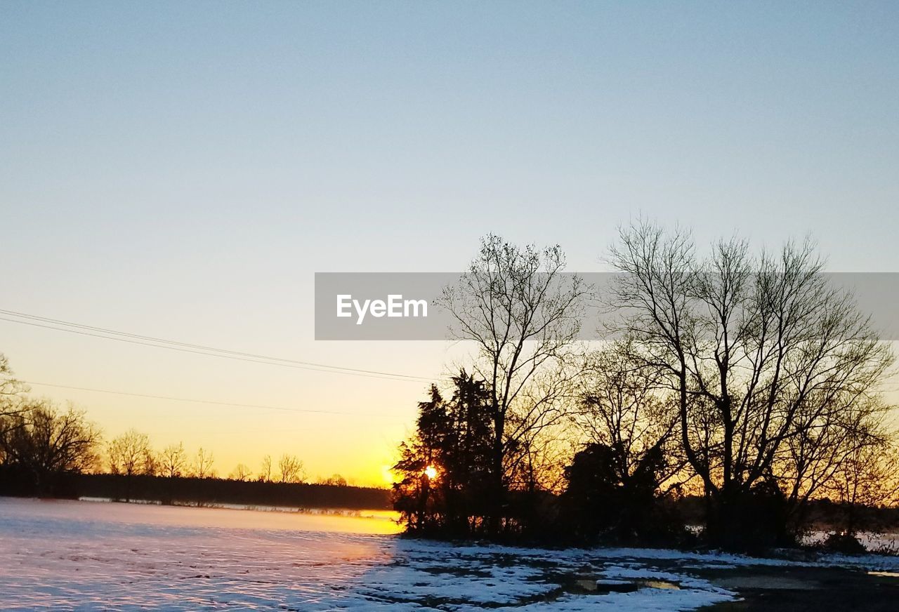 SCENIC VIEW OF FROZEN LAKE AGAINST CLEAR SKY DURING WINTER