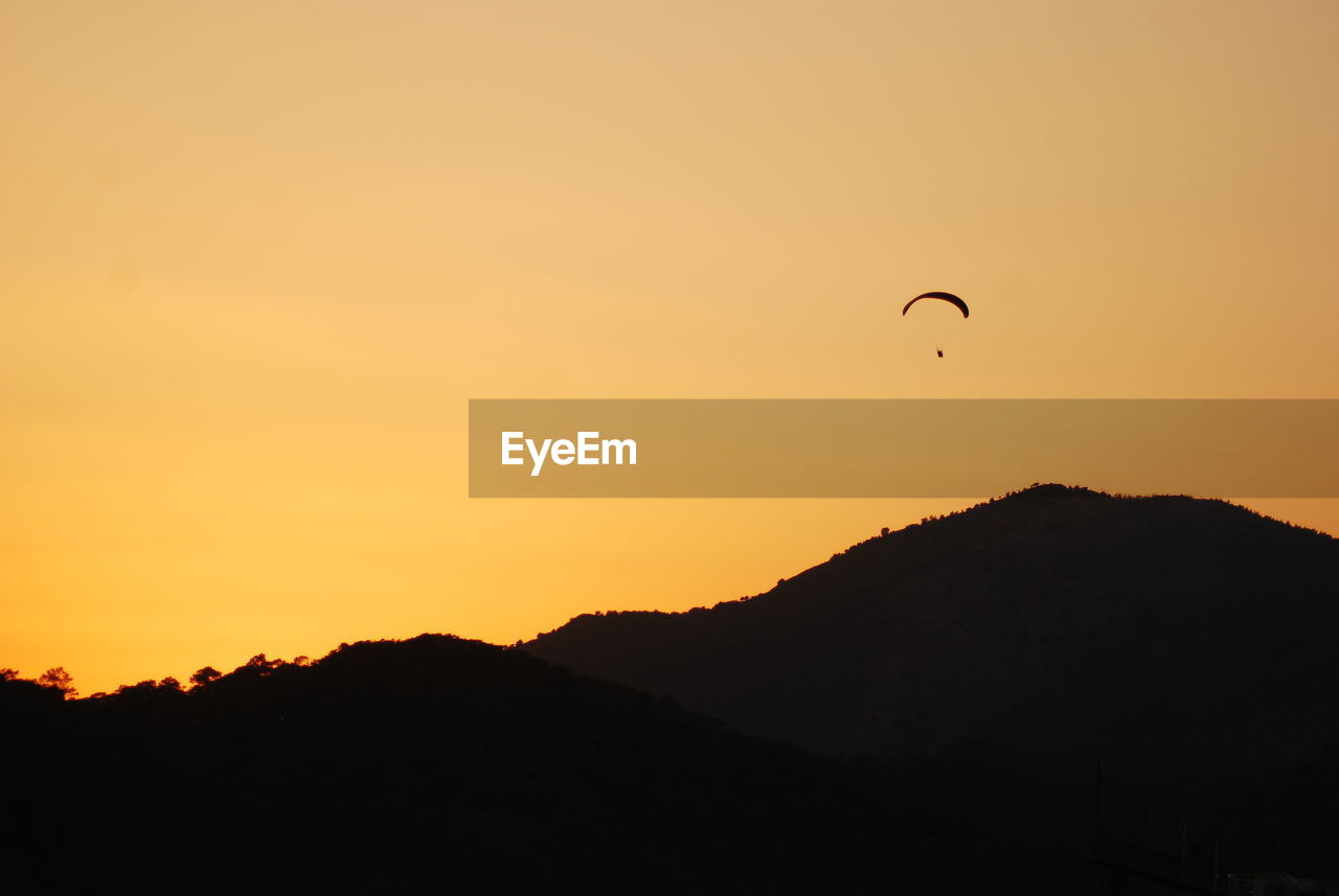 Scenic view of silhouette mountains against sky during sunset