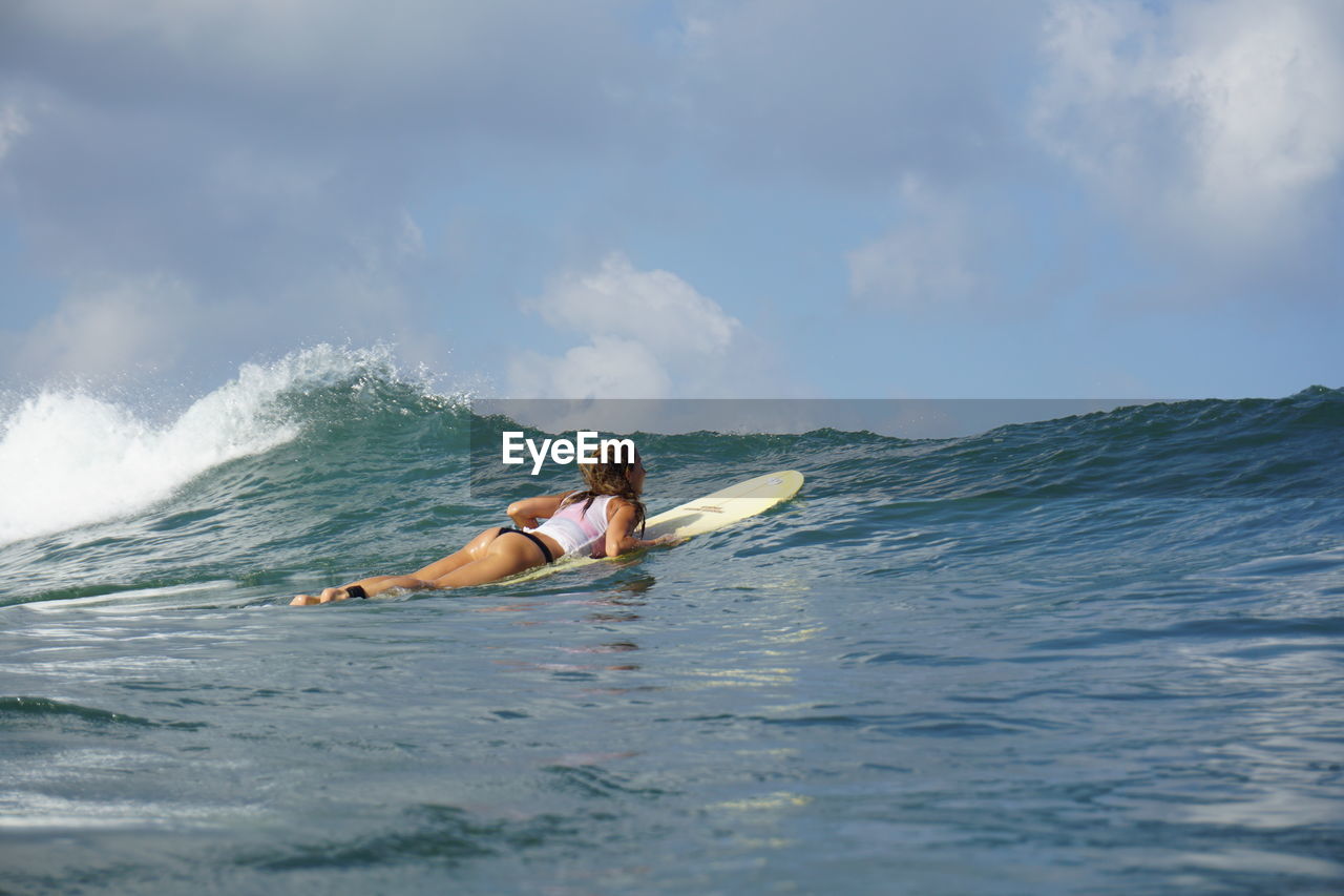 Woman surfing in sea