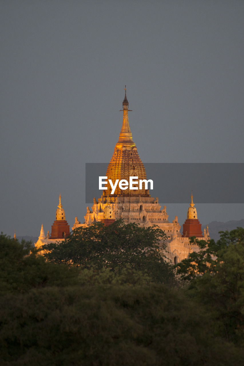 Illuminated historic temple against sky at dusk