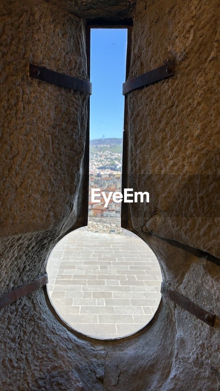 architecture, wall, built structure, history, no people, nature, wood, water, day, the past, rock, travel destinations, outdoors, building exterior, window, wall - building feature, sky, sea, travel, building, stone material, blue, tourism, entrance, geometric shape, ancient