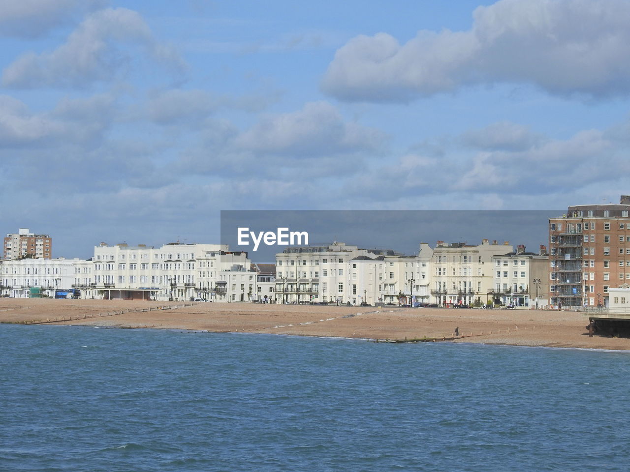 SEA AND BUILDINGS AGAINST SKY