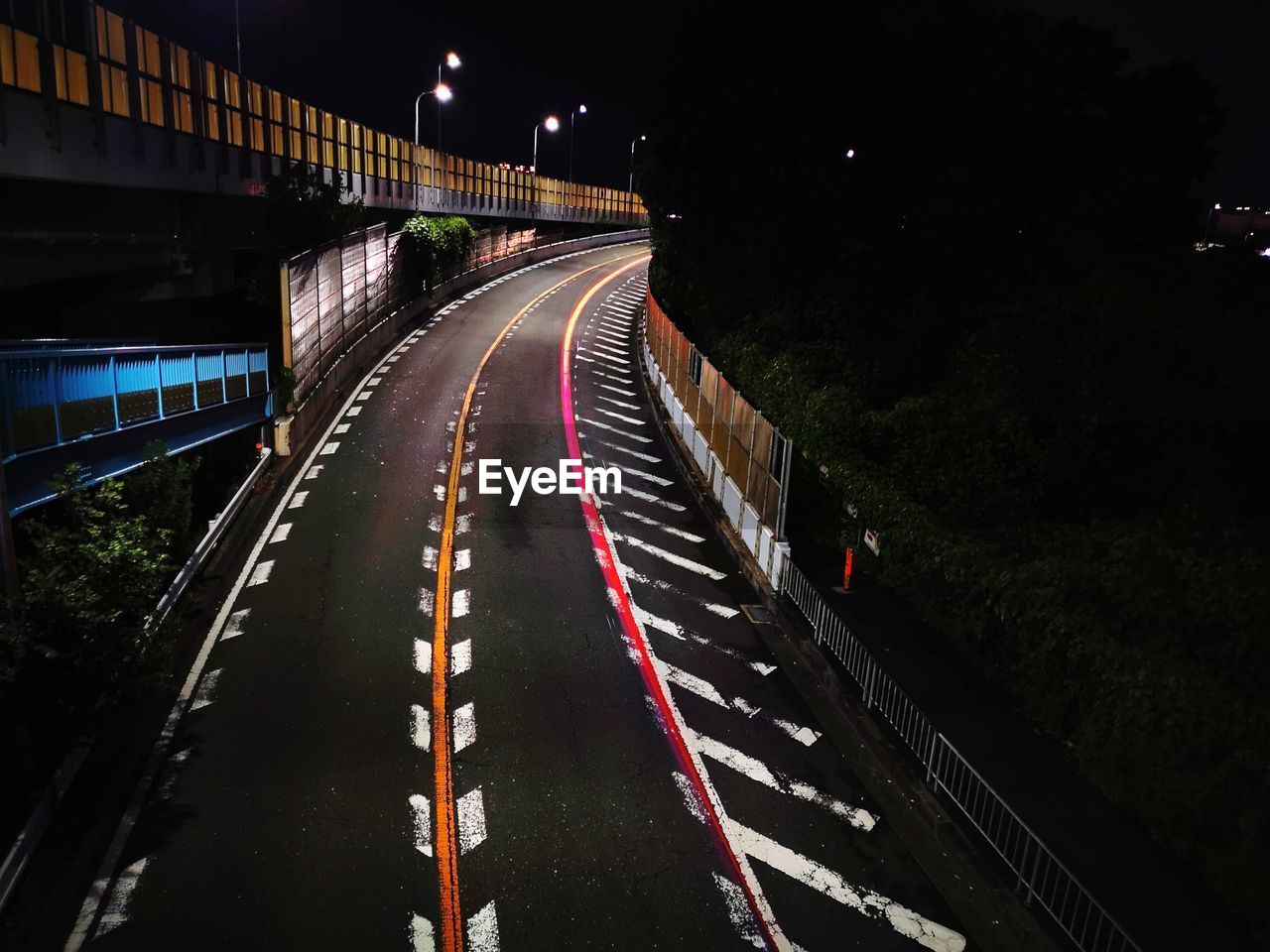 High angle view of light trails on highway at night