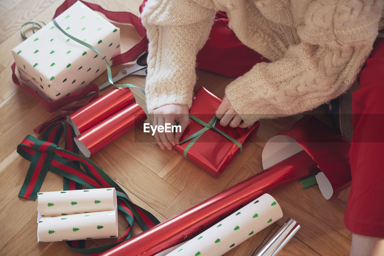 Woman's hands packing christmas presents