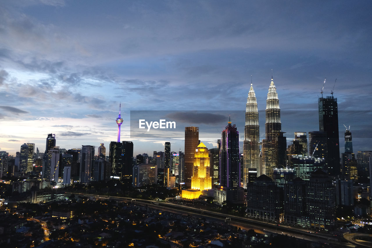 View of skyscrapers against cloudy sky