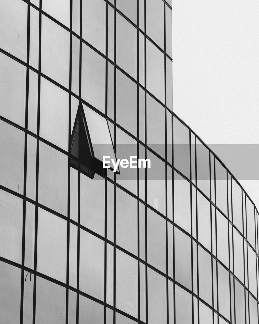 Low angle view of glass building against sky