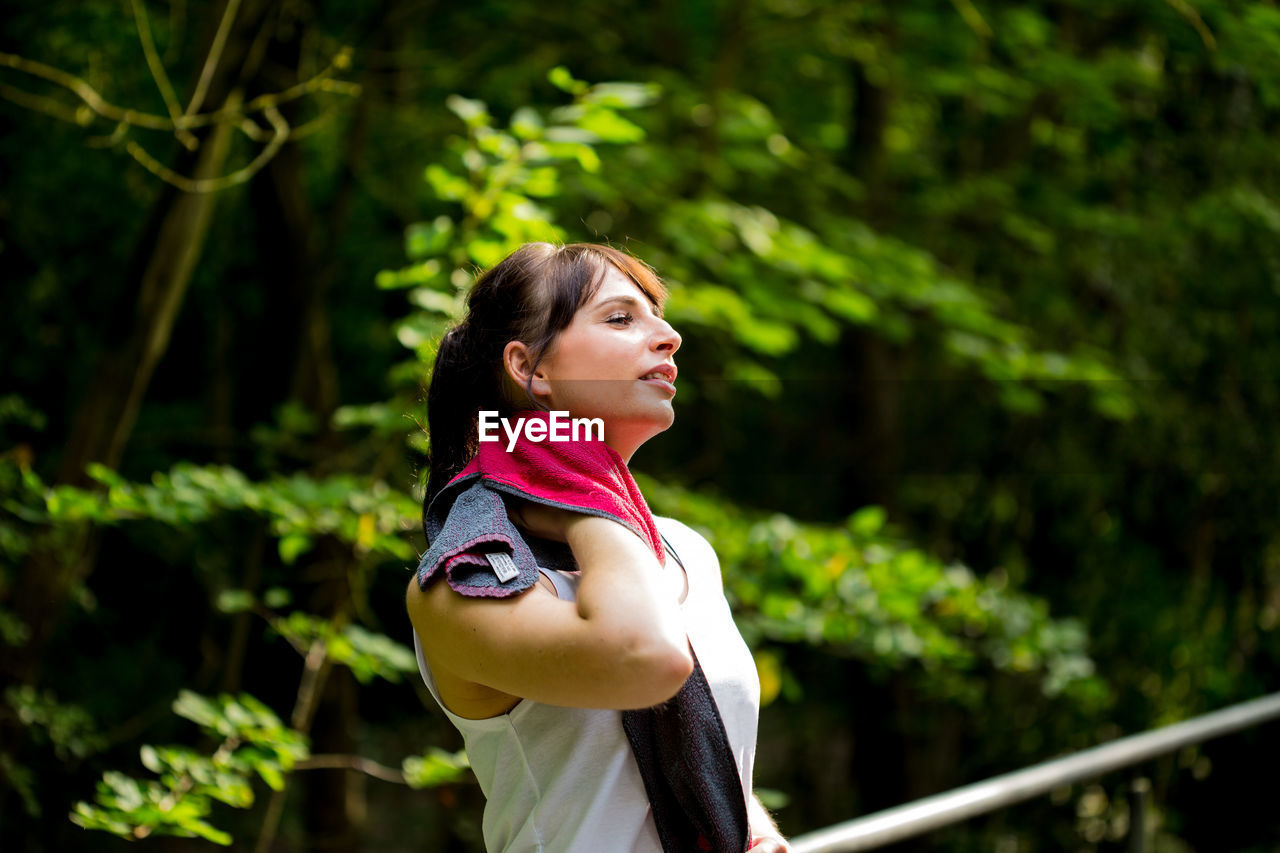 Woman wiping neck after exercising