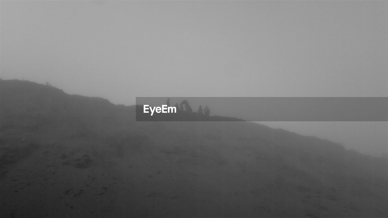 SCENIC VIEW OF SILHOUETTE MOUNTAIN IN FOGGY WEATHER