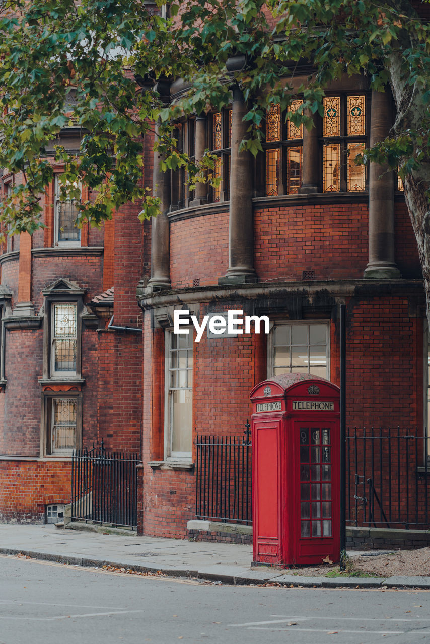 Red phone box on a street in clerkenwell, london, uk.