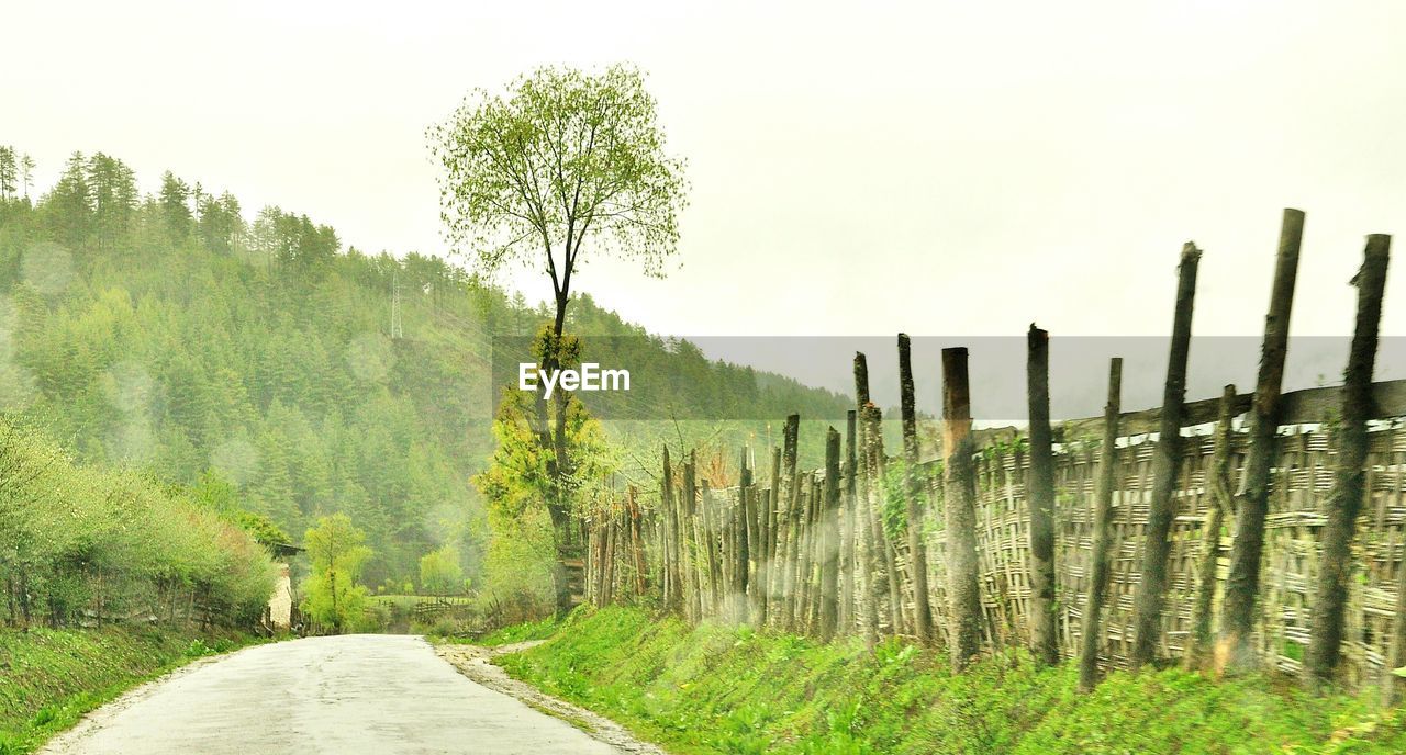 Empty road along countryside landscape