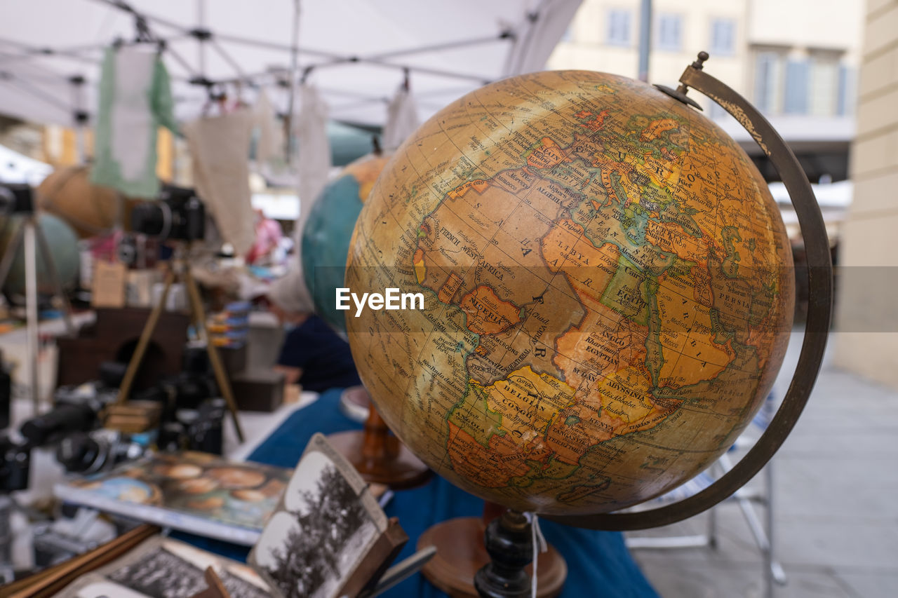 Old globe on stand of antiques market in arezzo italy