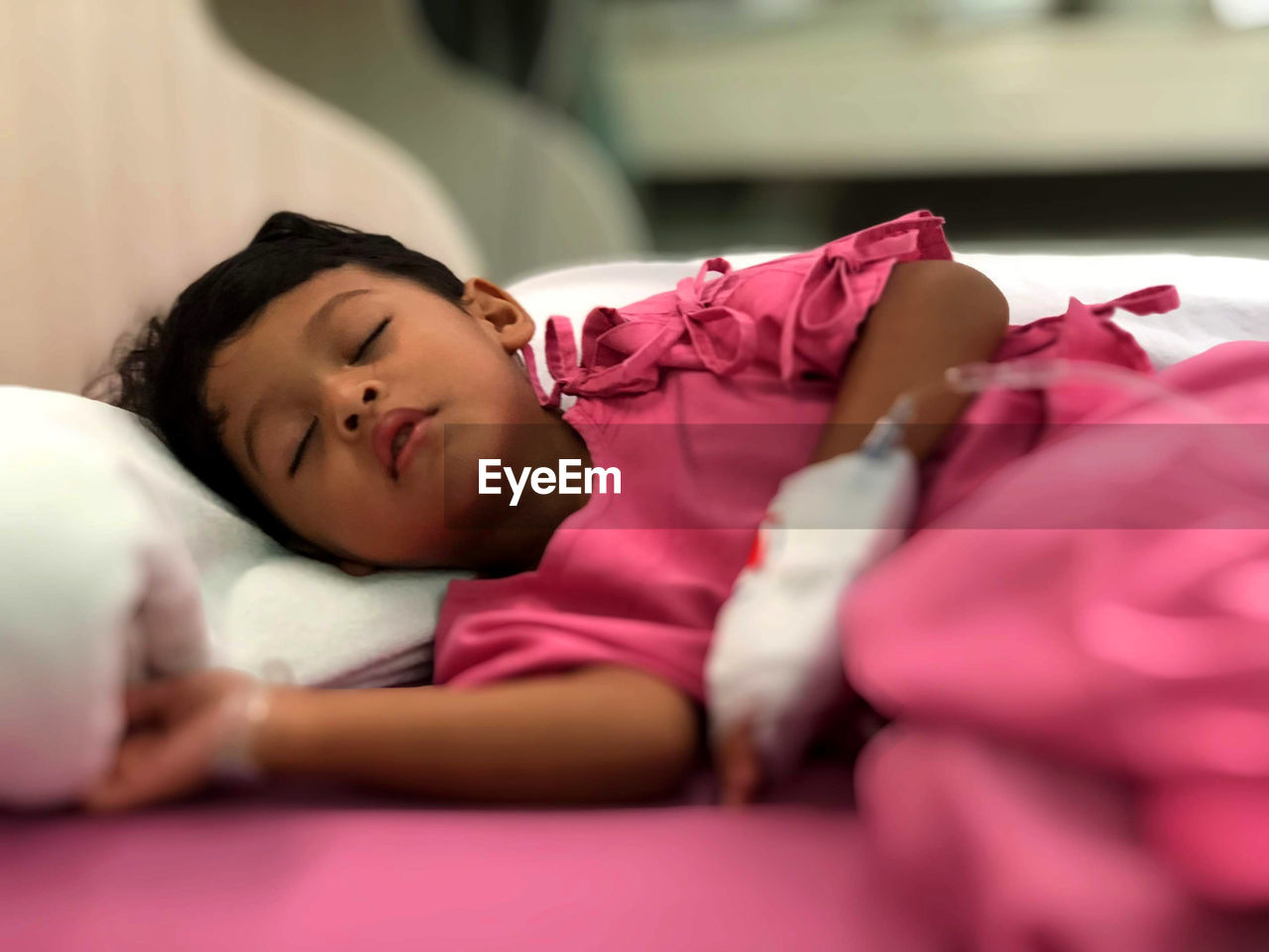 Girl sleeping on bed in hospital