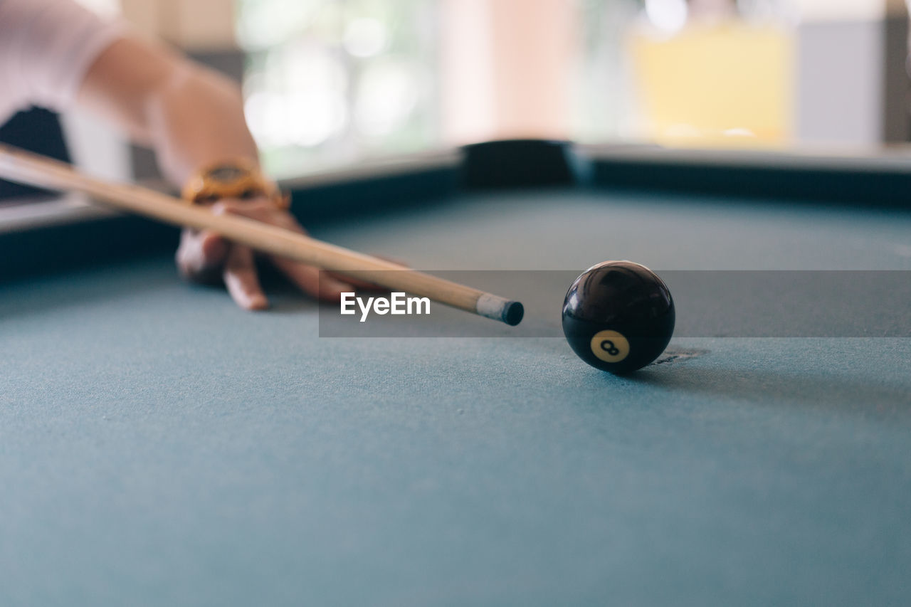 Cropped hand of person playing snooker