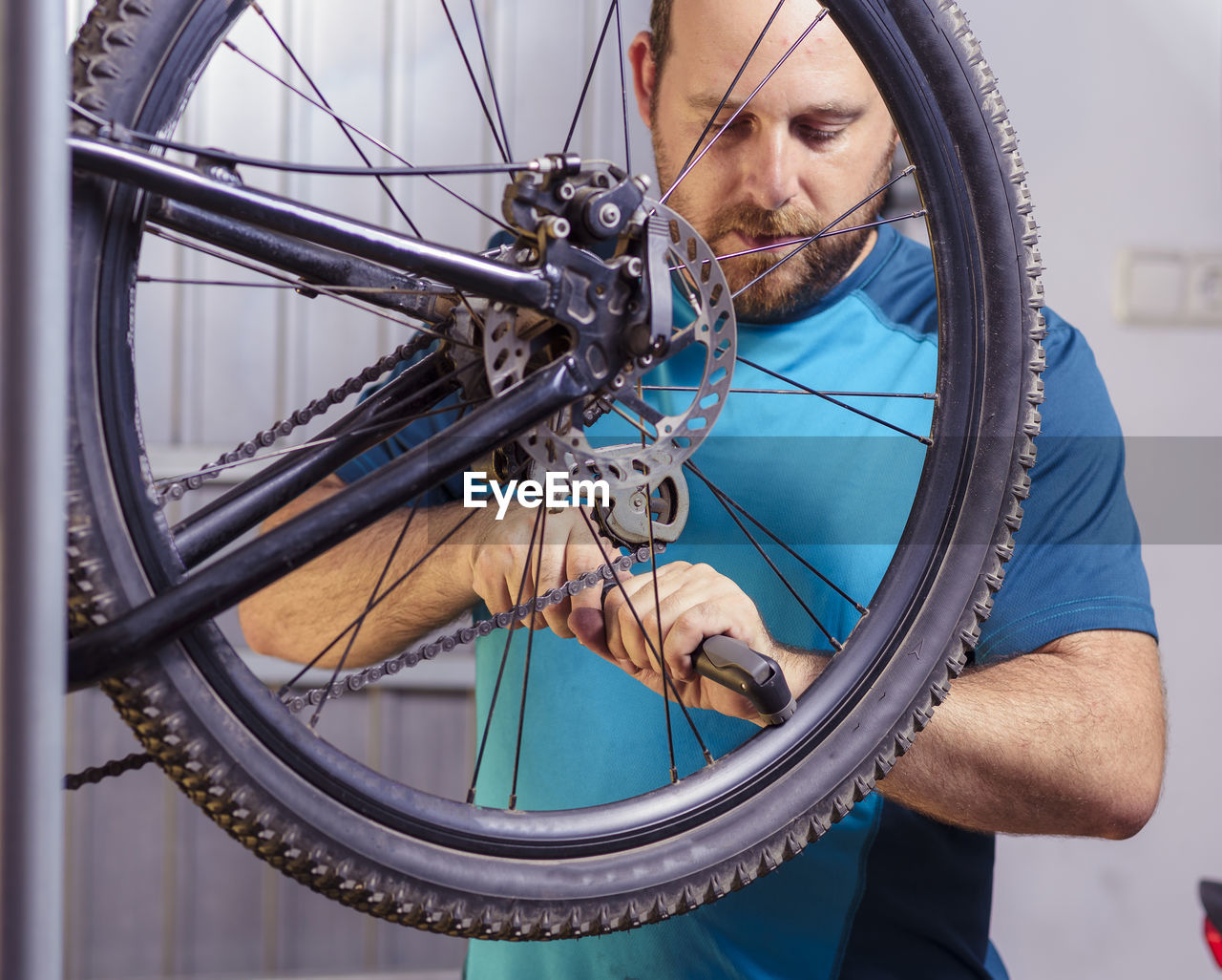 Man repairing bicycle wheel