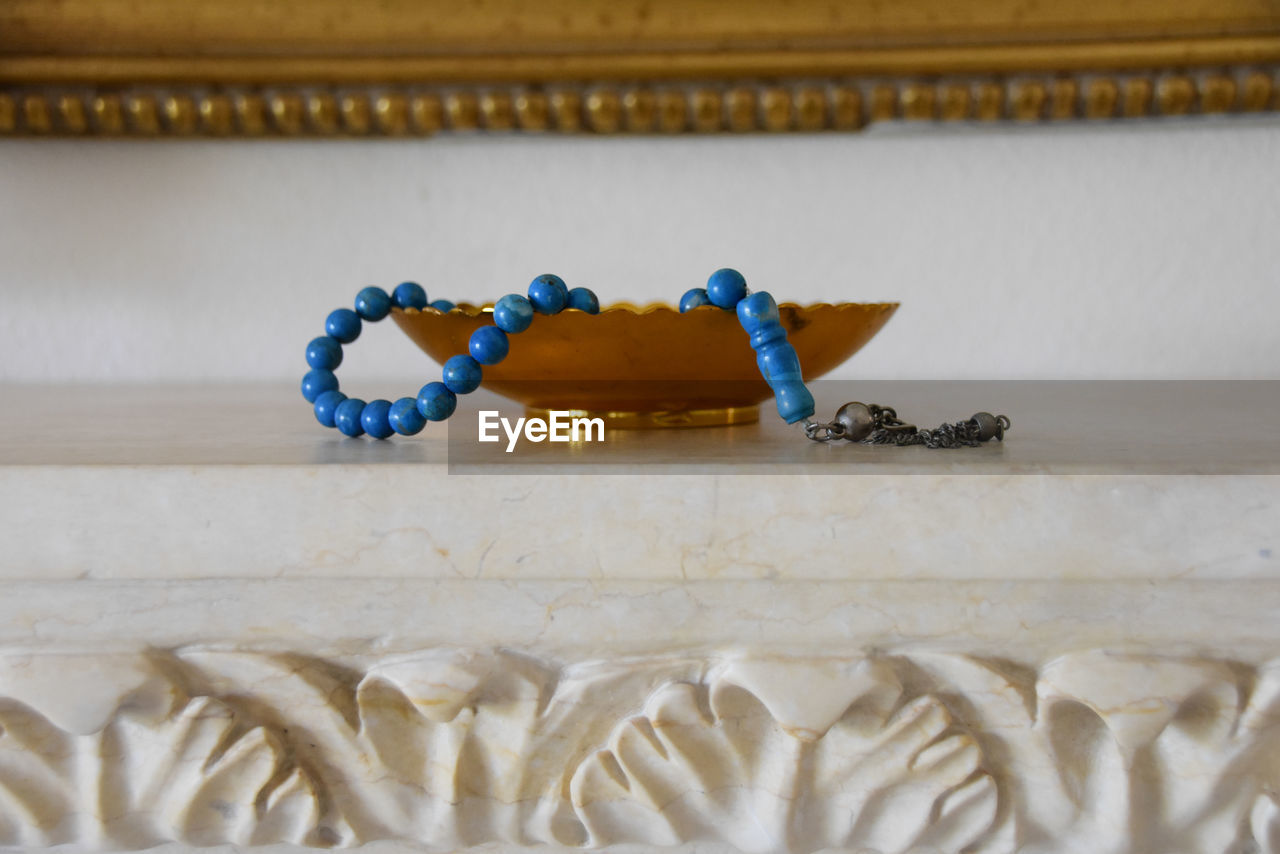 Close-up of bead necklace in container