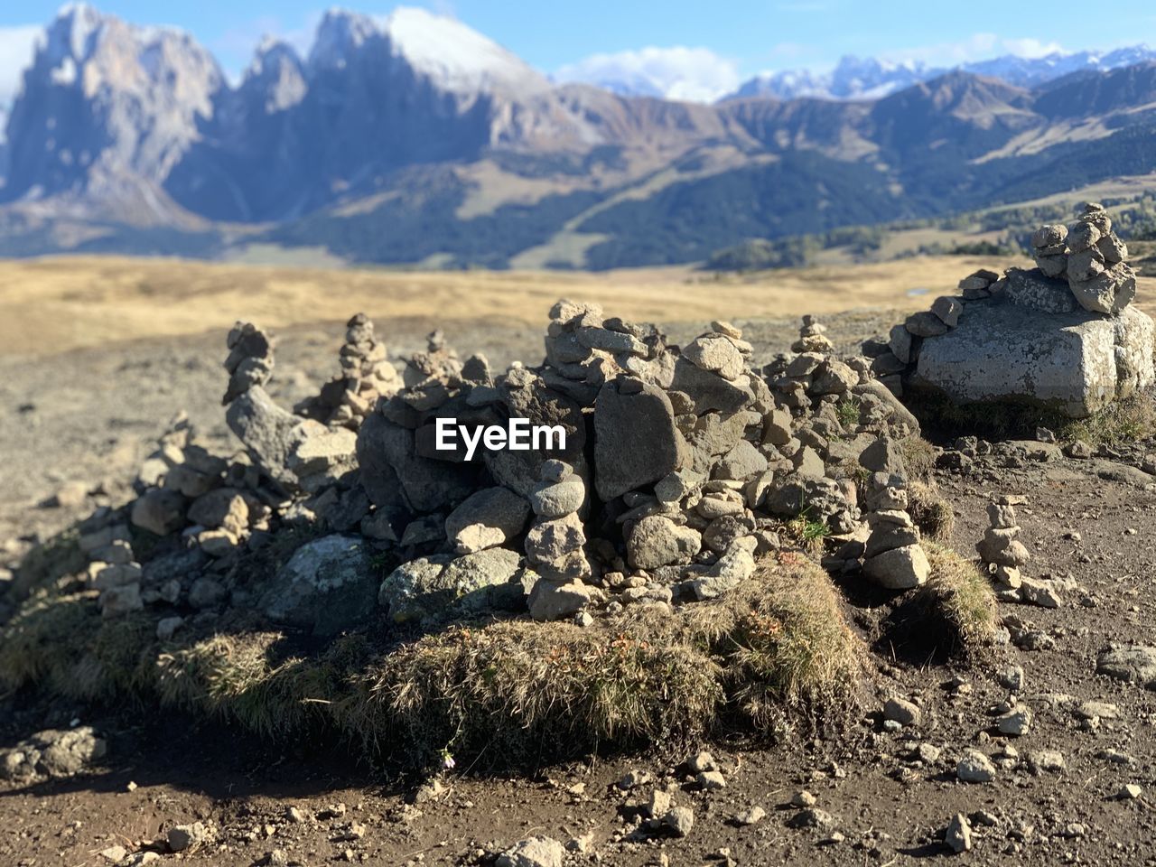 Rocks on field against mountains