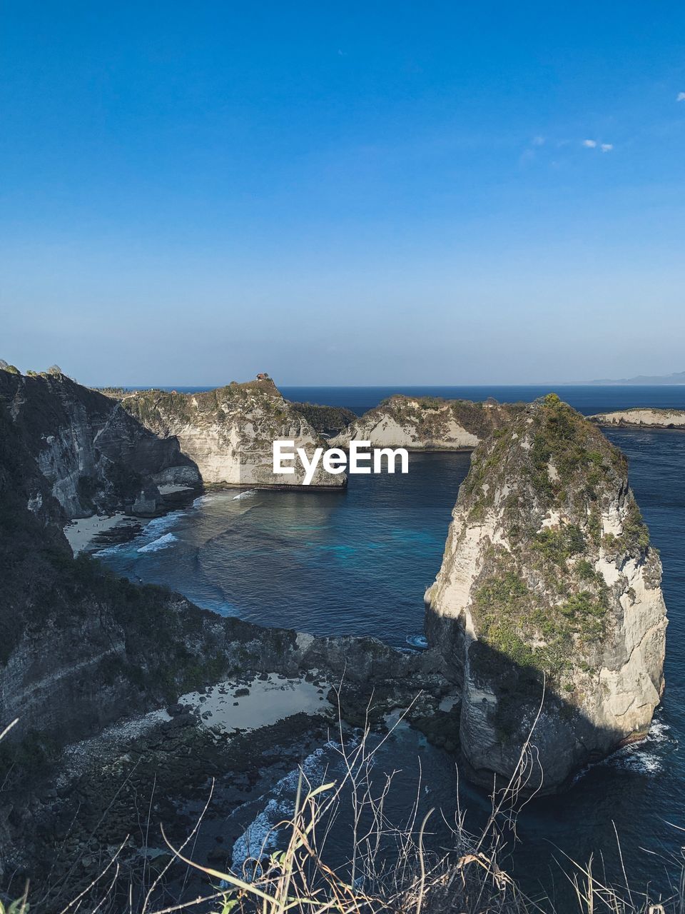 Scenic view of sea against clear blue sky