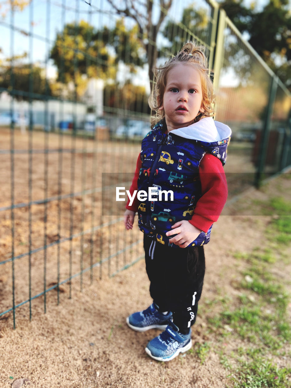 child, childhood, one person, full length, clothing, cute, spring, portrait, toddler, nature, day, innocence, blond hair, lifestyles, smiling, looking at camera, happiness, casual clothing, emotion, female, women, baby, outdoors, front view, standing, leisure activity, playground, focus on foreground, person, looking, preschool, fun, sports, plant