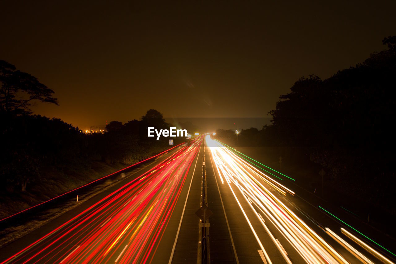 High angle view of light trails on highway at night