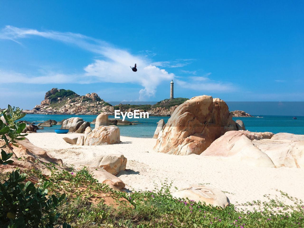 Rocks on beach against sky - ke ga lighthouse