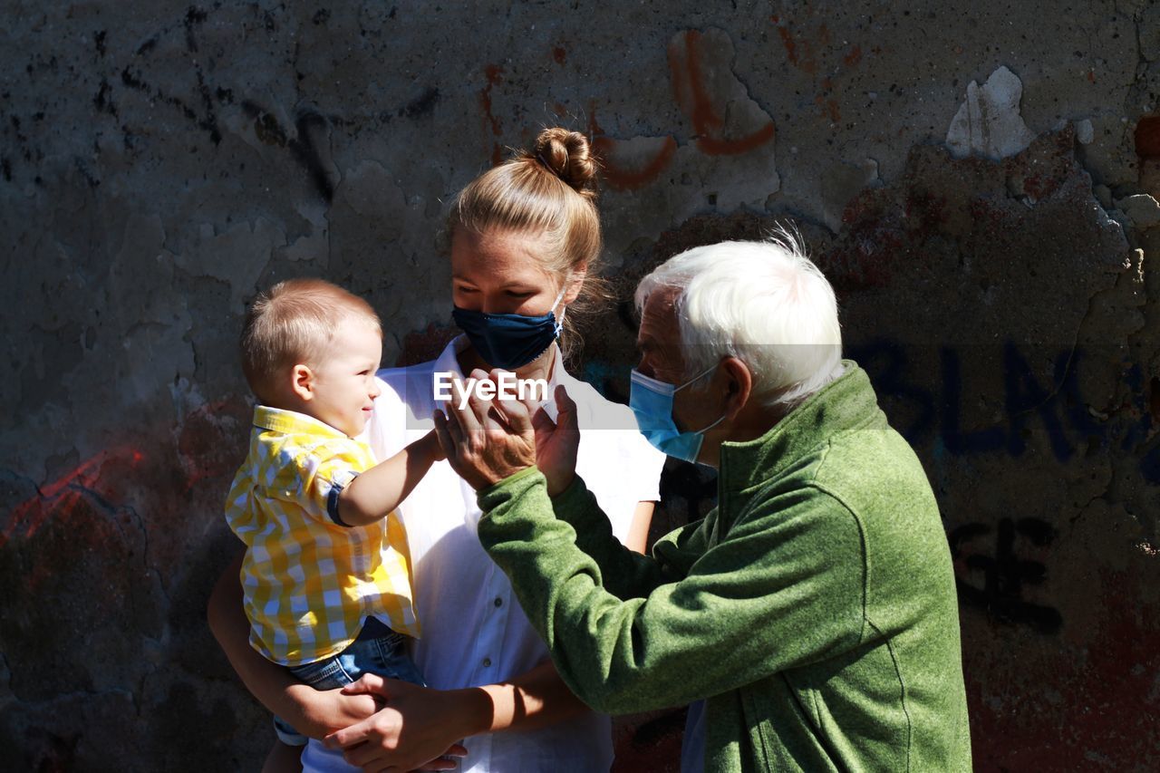 People with mask standing outdoors