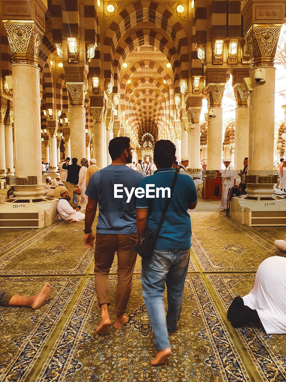 People walking inside masjid annabawi, madinah, saudi arabia.