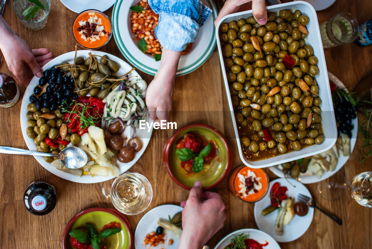 Cropped image of hands with food served on table