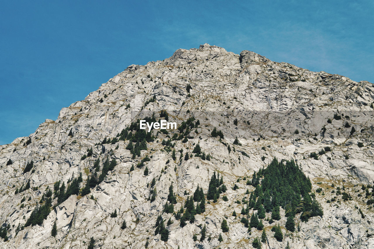 Low angle view of rock formations against sky