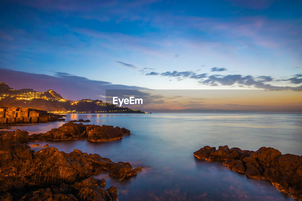 SCENIC VIEW OF SEA AT SUNSET