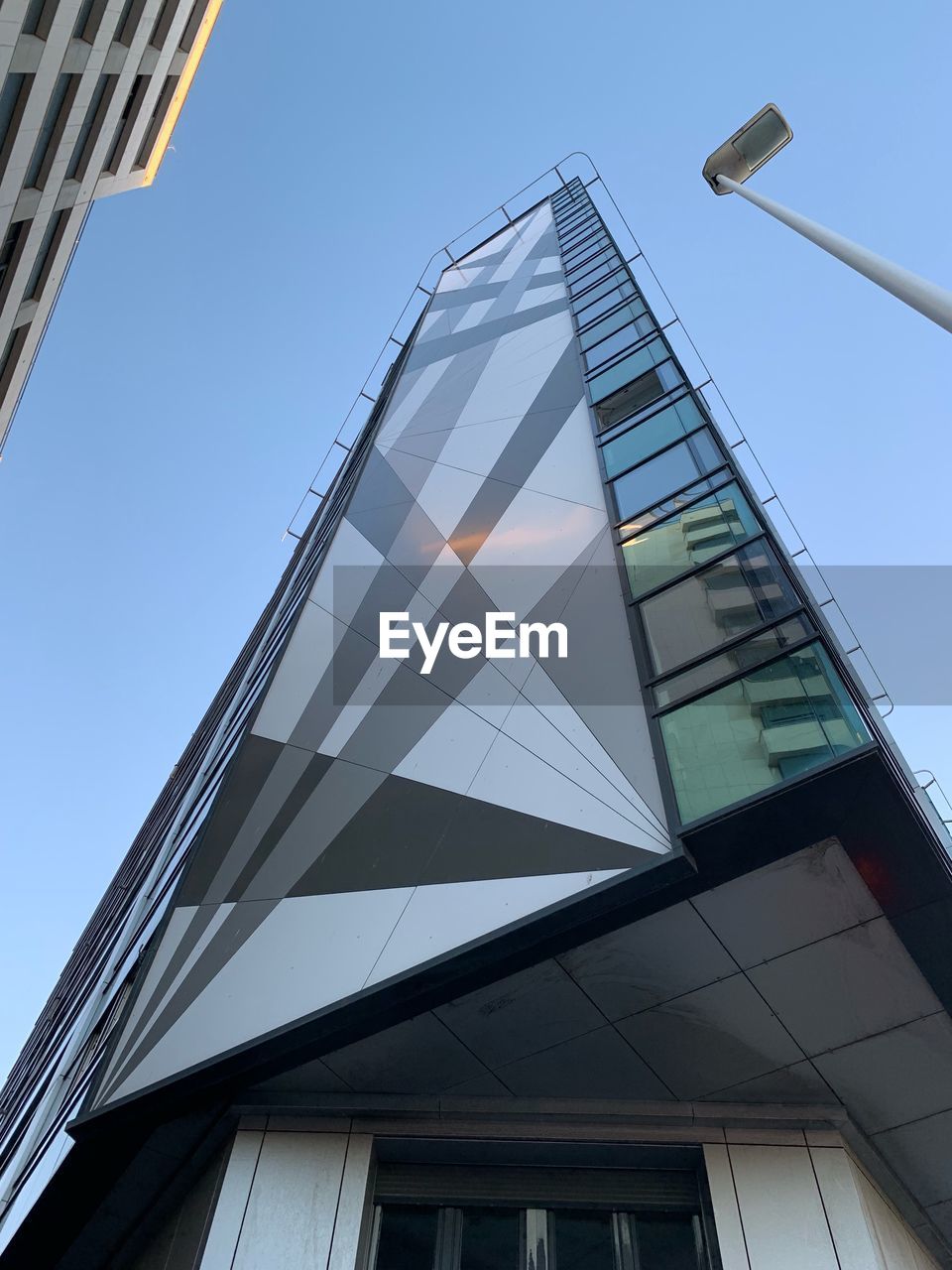 LOW ANGLE VIEW OF MODERN BUILDINGS AGAINST CLEAR SKY