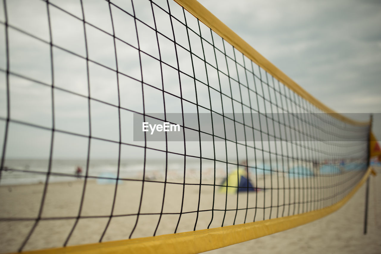 CLOSE-UP OF NET AGAINST SKY IN BACKGROUND