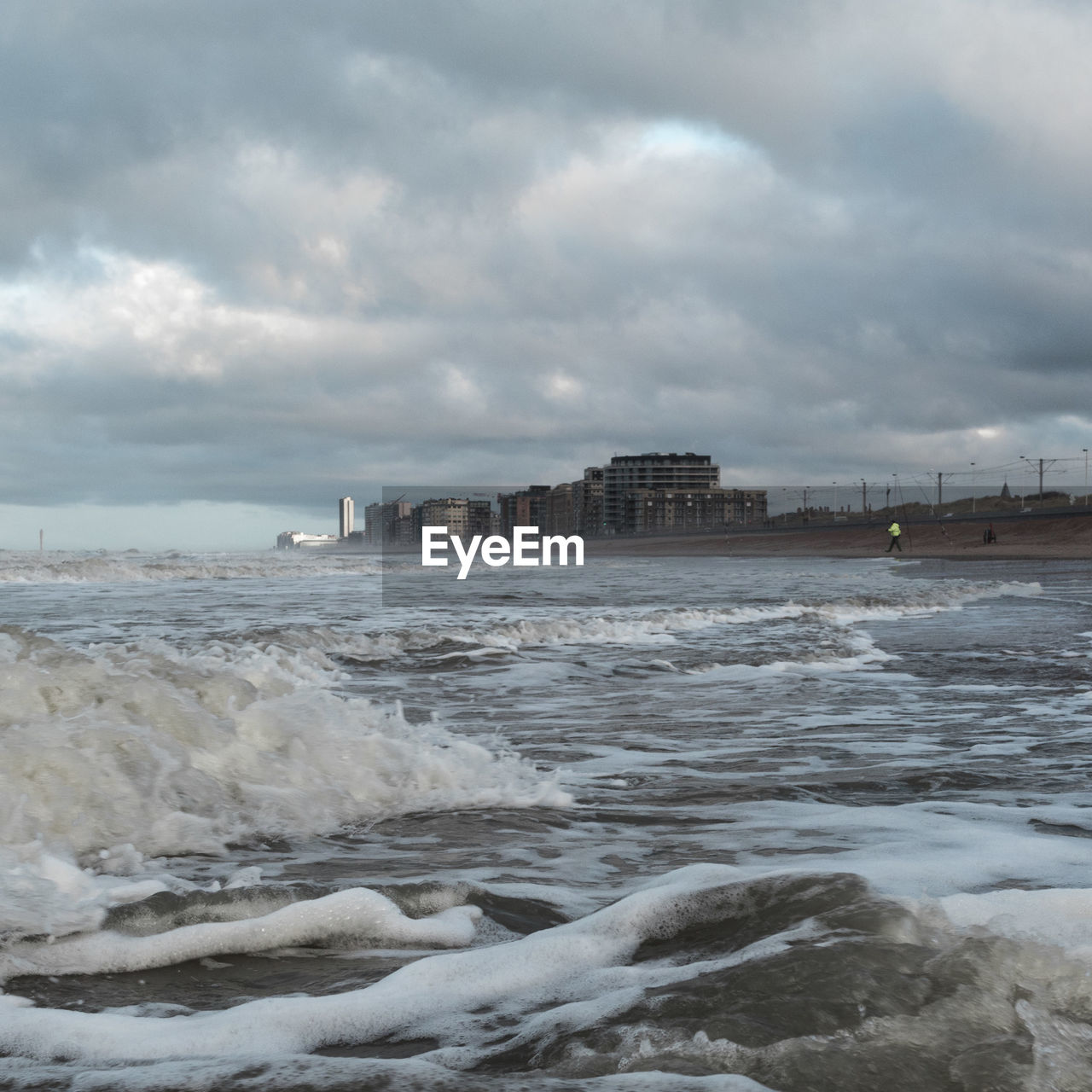 Scenic view of sea by city against sky