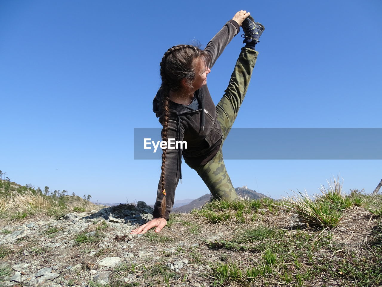 LOW ANGLE VIEW OF MAN AGAINST BLUE SKY