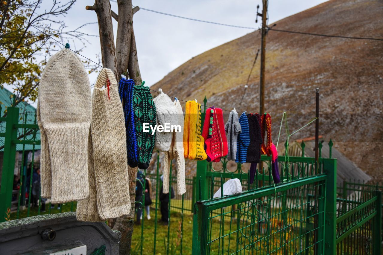 Laundry drying on clothesline against mountain