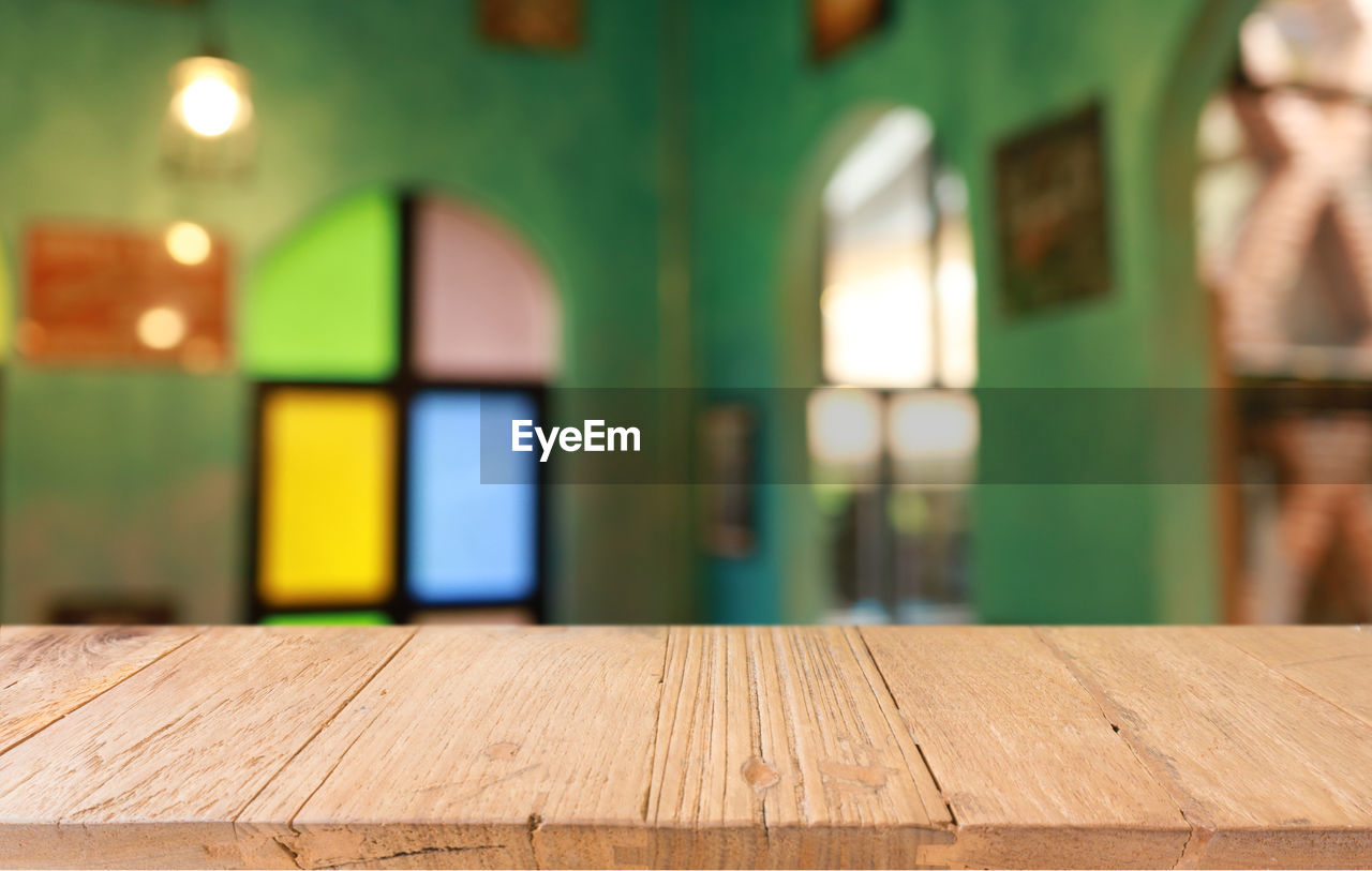 wood, architecture, indoors, focus on foreground, no people, building, built structure, window, green, table, flooring