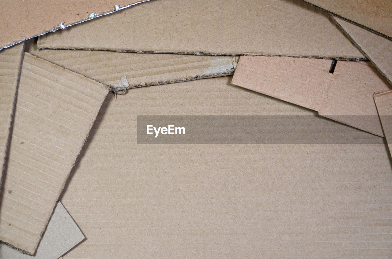 HIGH ANGLE VIEW OF PAPER IN BOX ON FLOOR