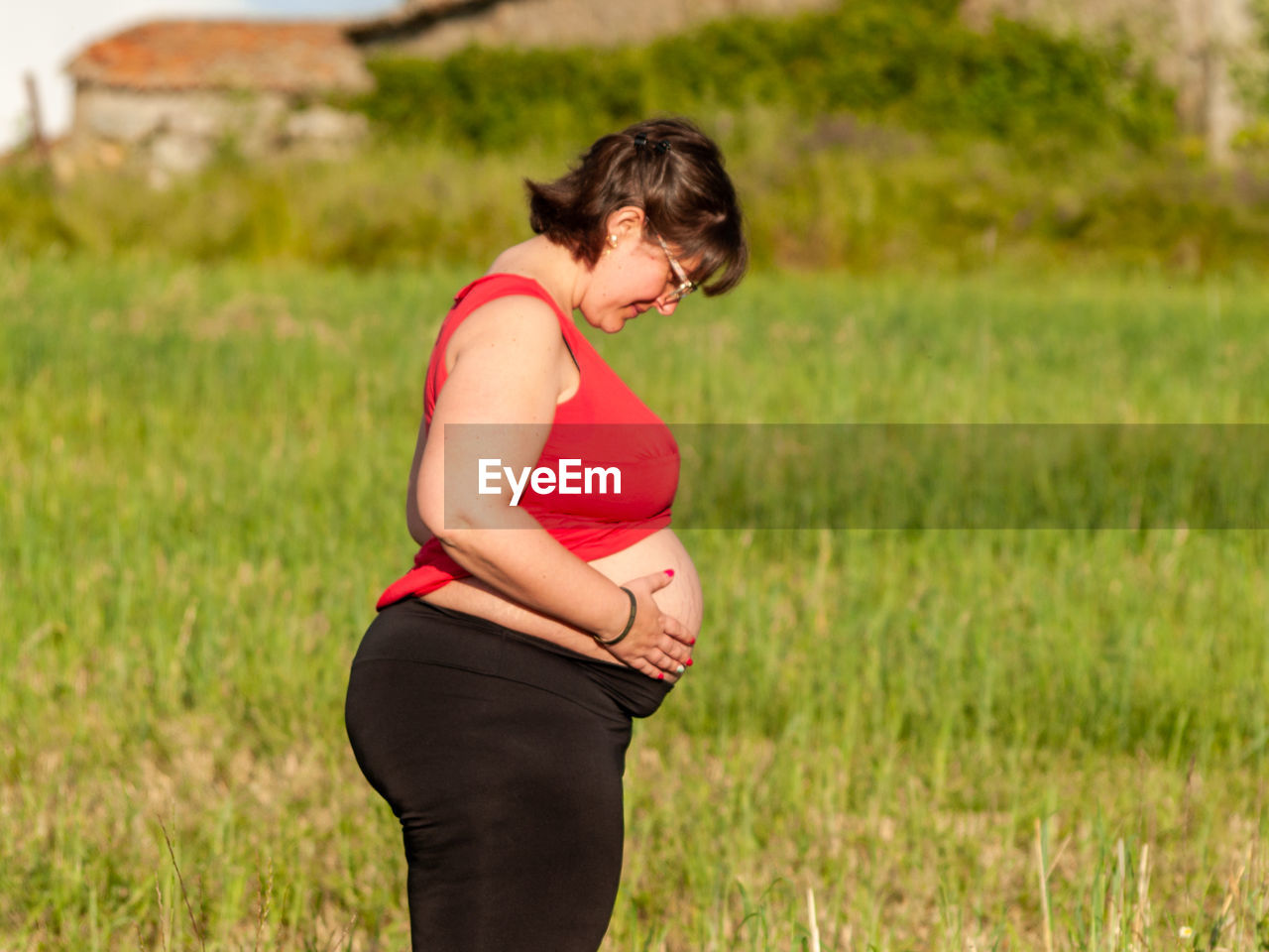 Pregnant woman standing on field