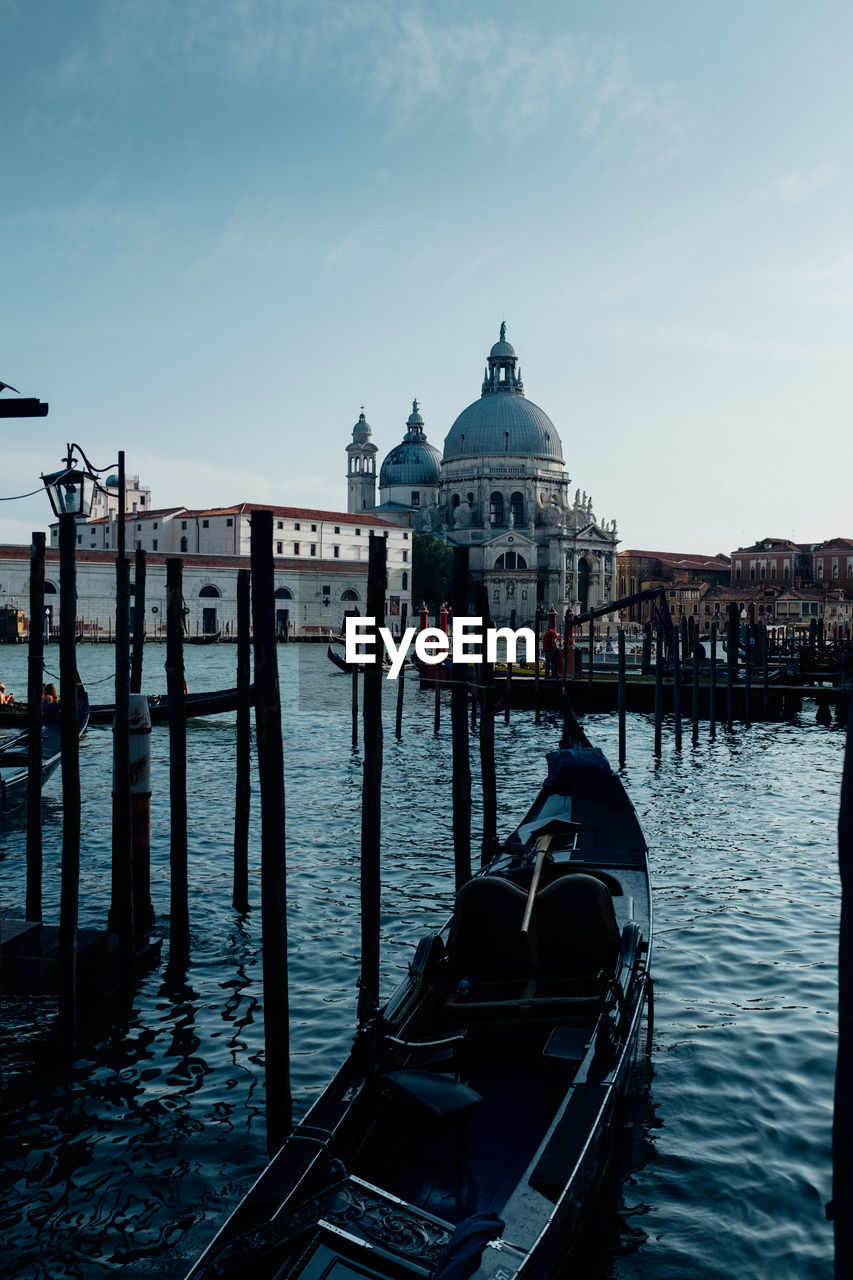 Gondolas moored at port against st mark cathedral