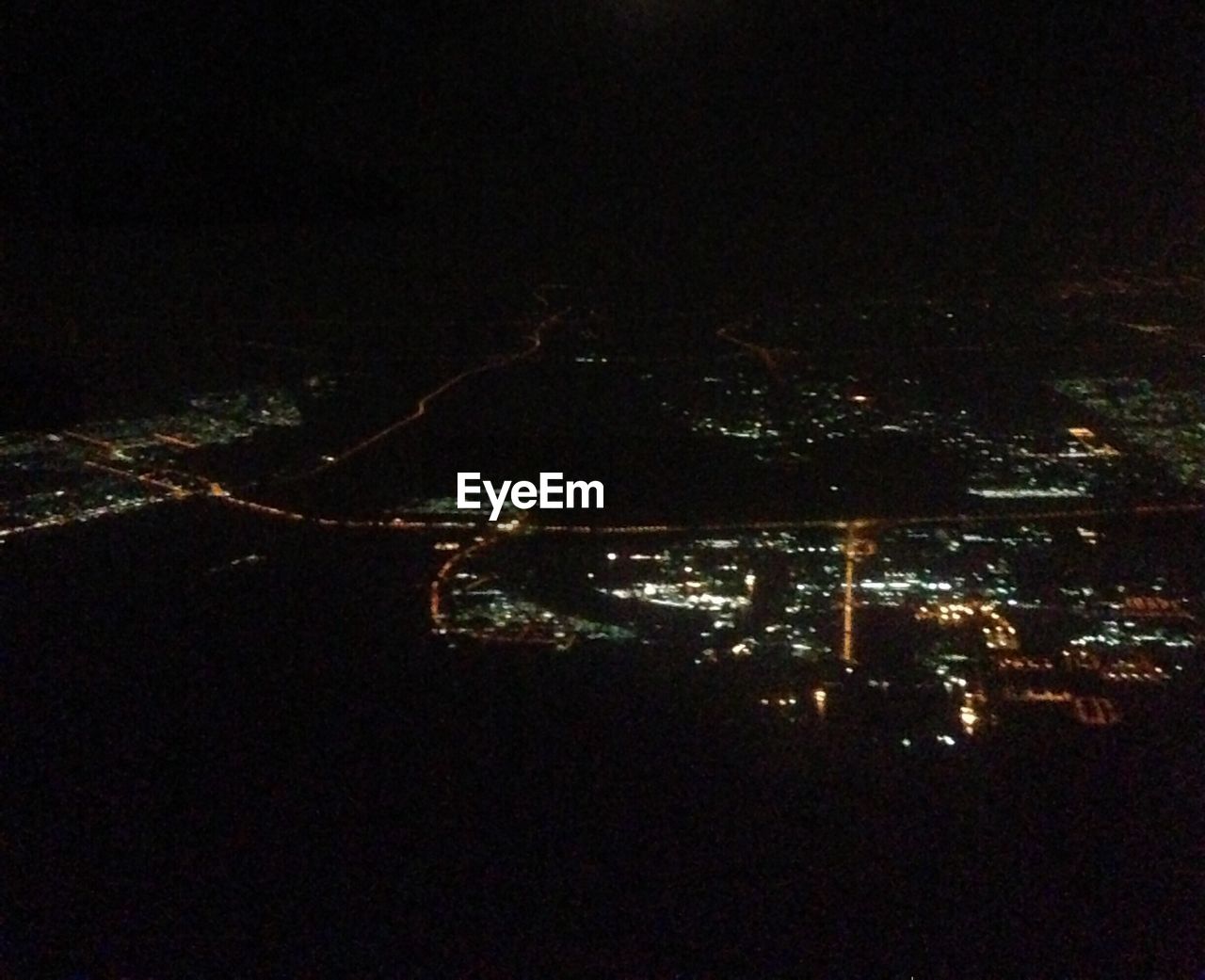 VIEW OF ILLUMINATED CITYSCAPE AT NIGHT