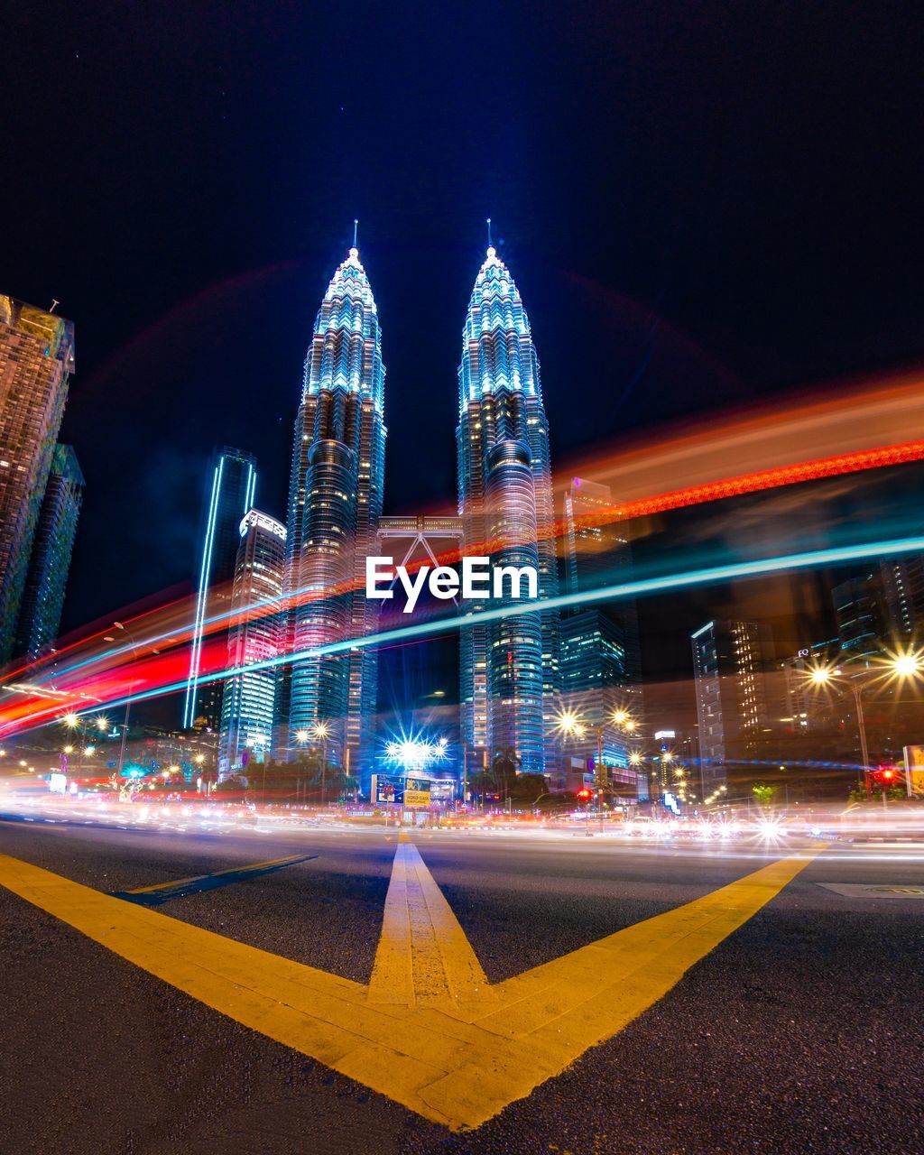 Light trails on city street against buildings at night