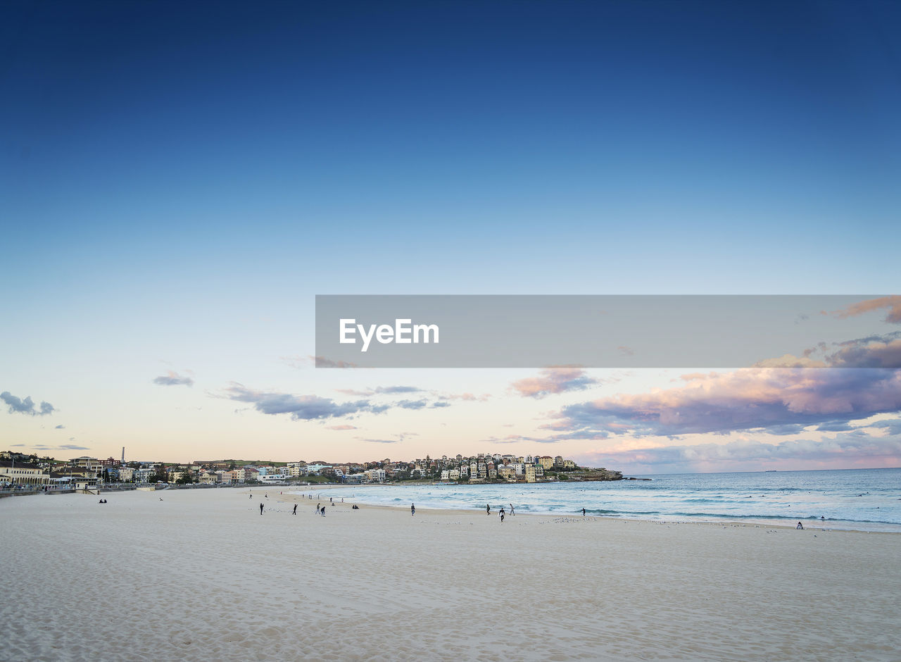 Scenic view of beach against cloudy sky