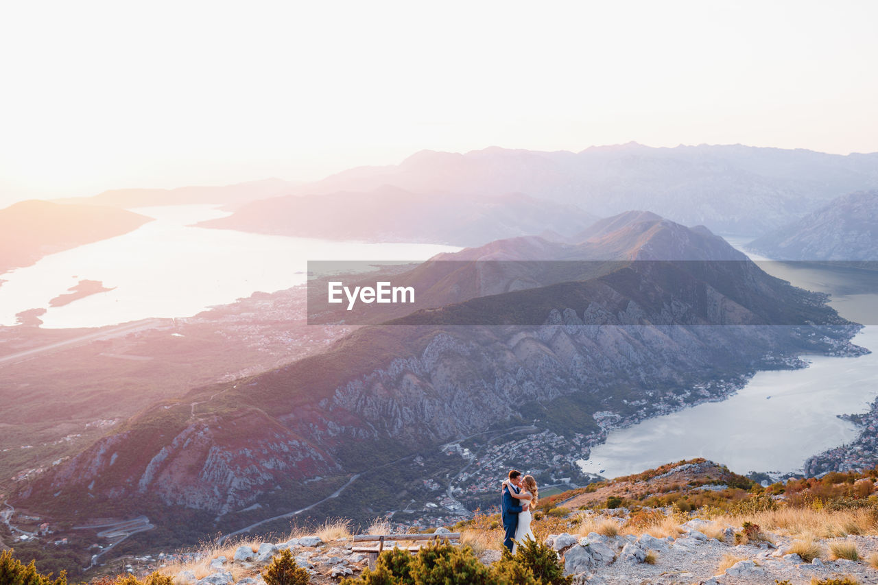 Man standing on mountain against sky