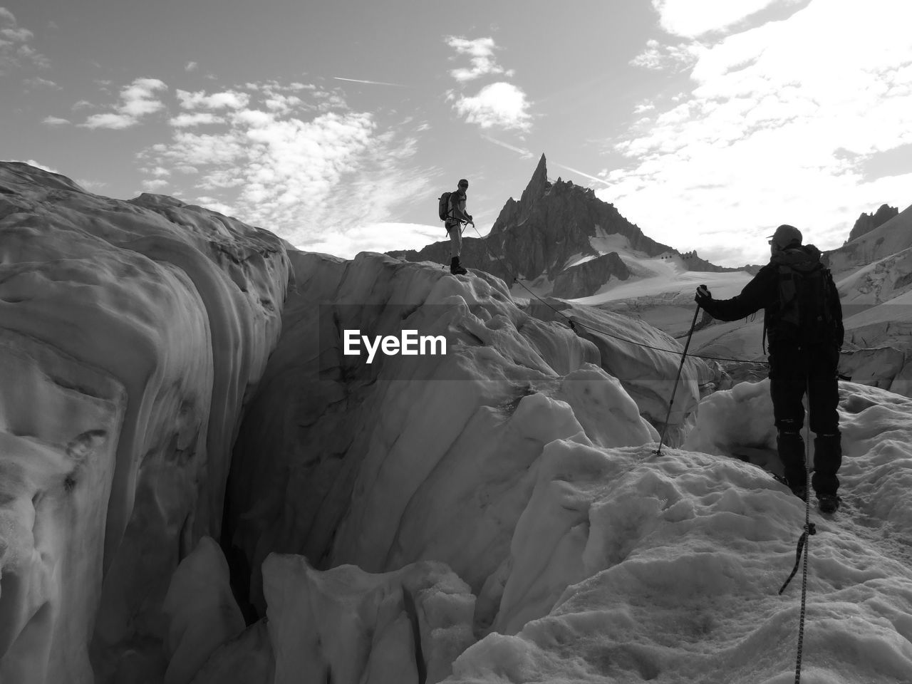 PEOPLE STANDING ON SNOW AGAINST SKY