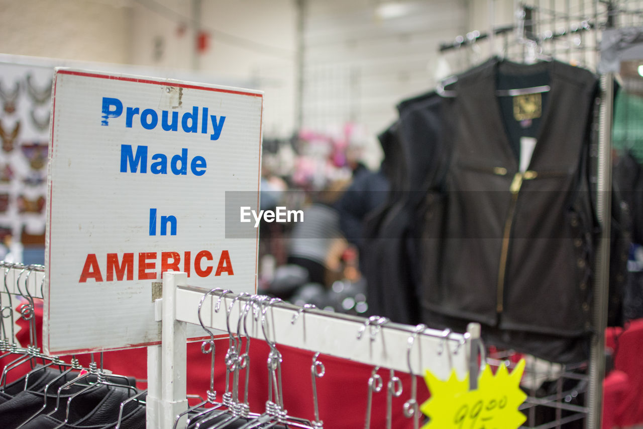 Close-up of information sign on rack in clothing store