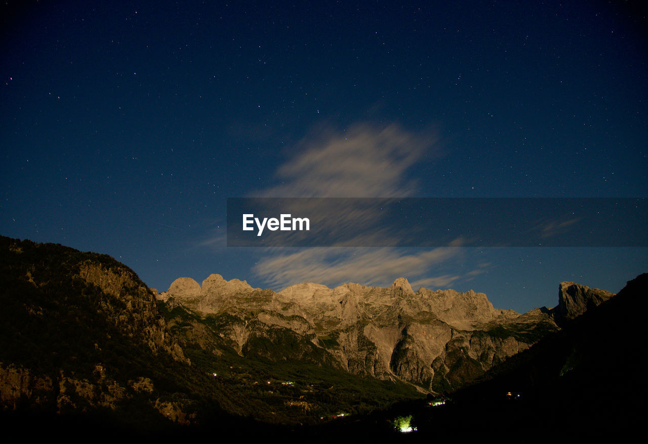 Low angle view of mountains against sky at night