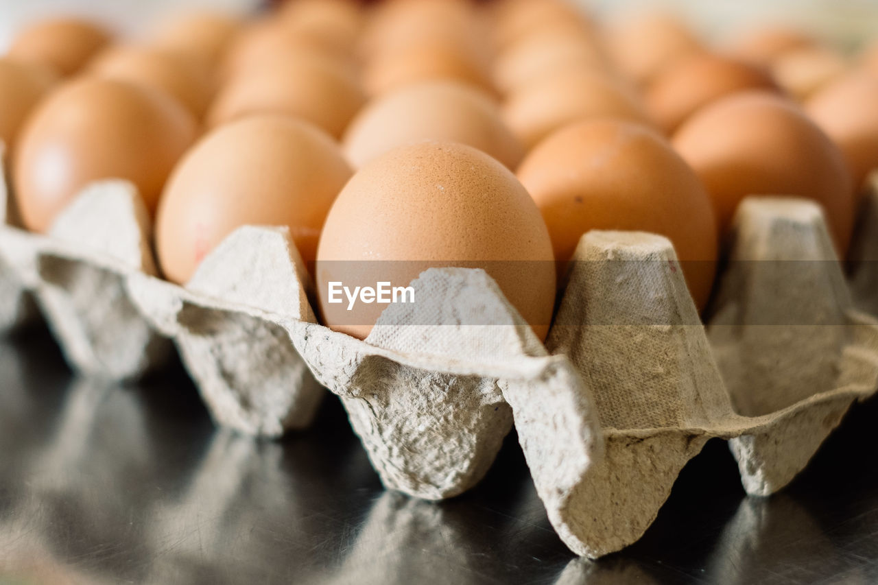 Close-up of eggs in egg carton on table