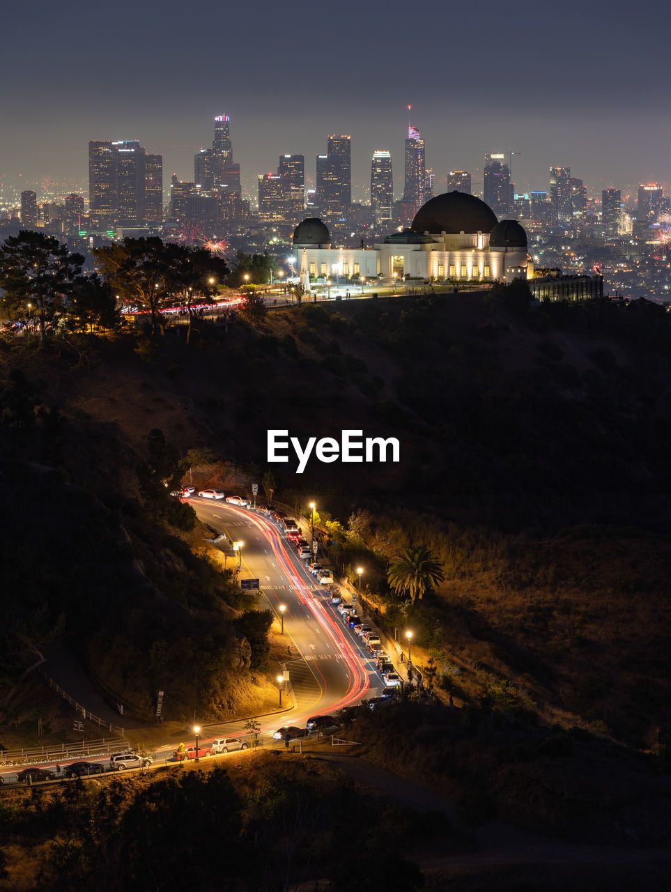 Fourth of july fireworks over griffith observatory with the los angeles skyline in the distance