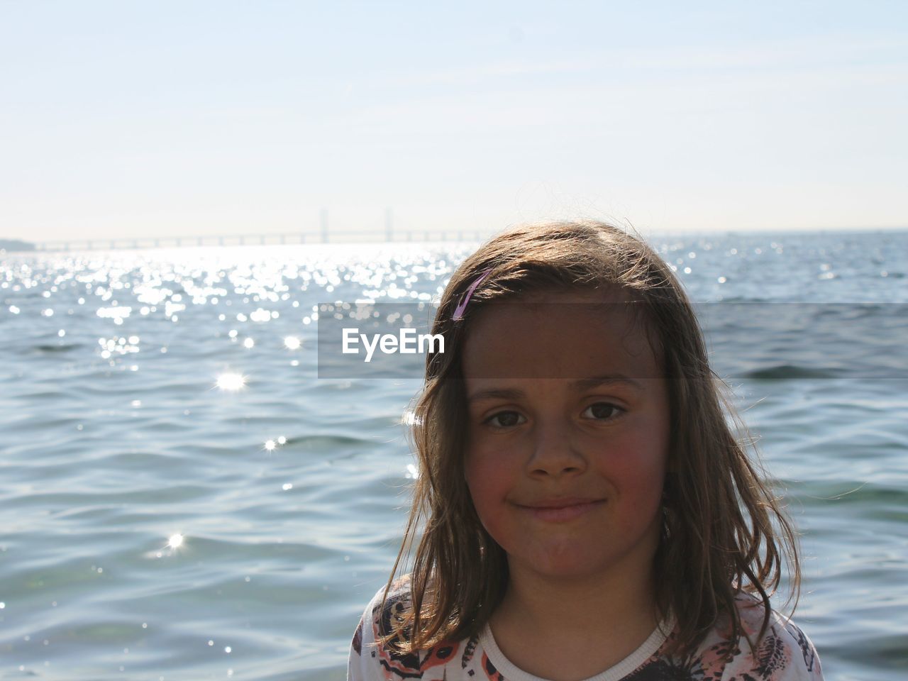 Portrait of smiling girl against sea